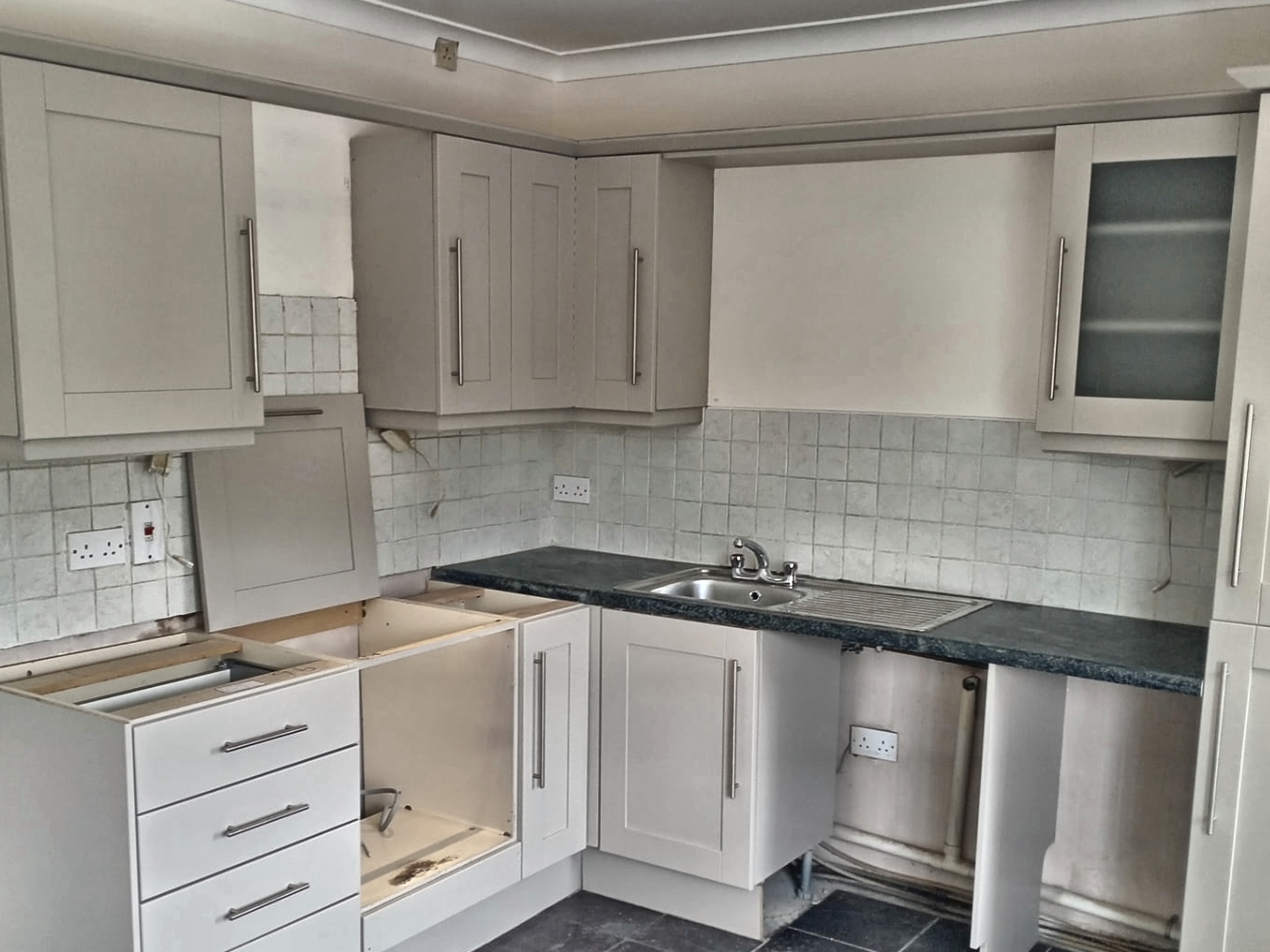 Grey kitchen cabinets after professional respraying