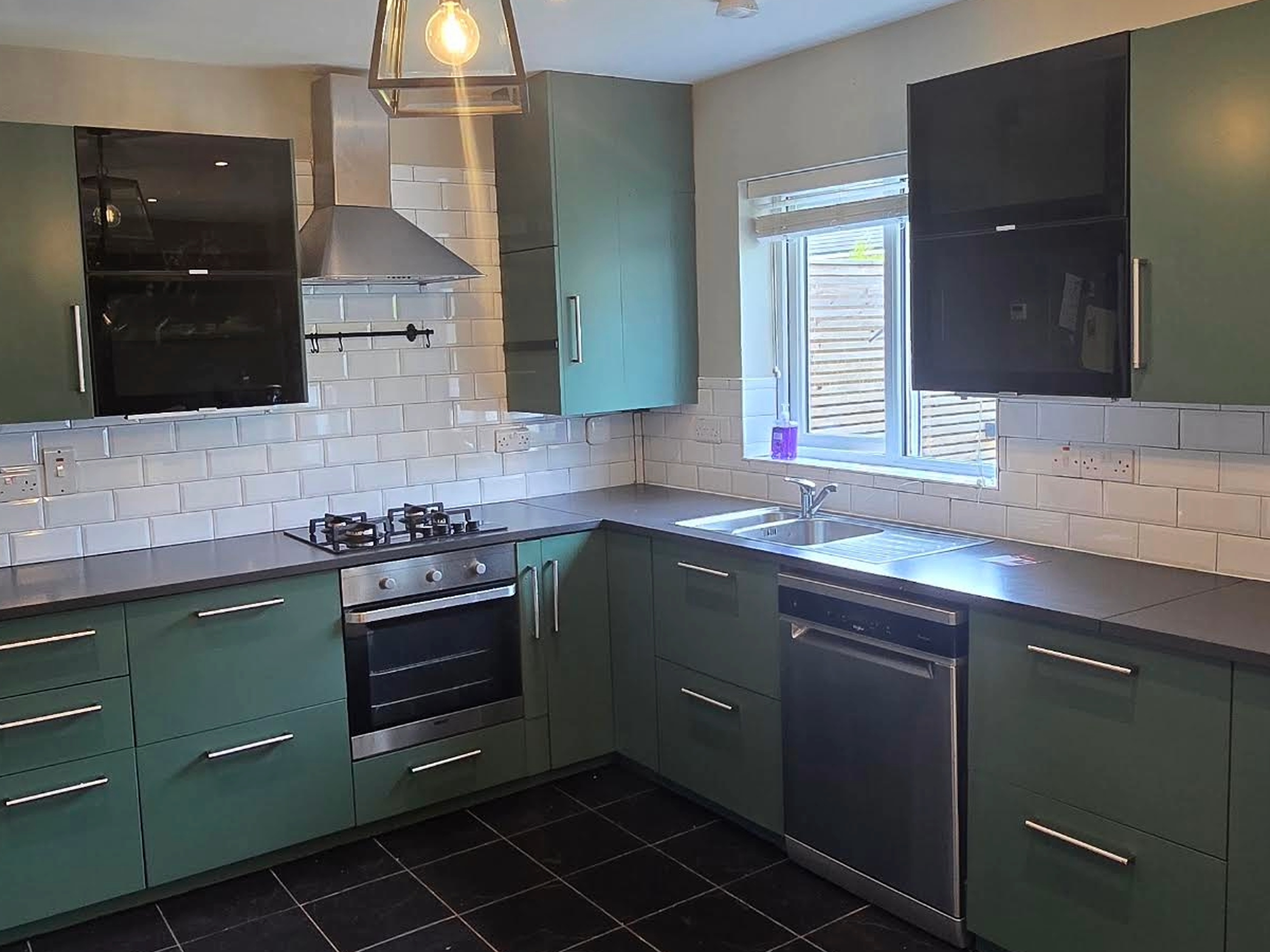 Green kitchen cabinets after professional respraying